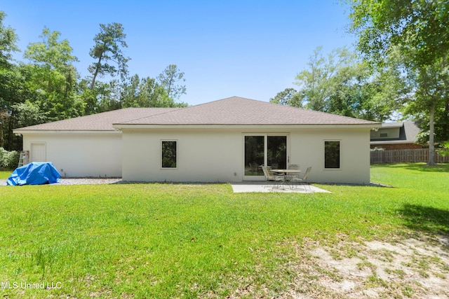 rear view of property featuring stucco siding, a patio area, and a shingled roof