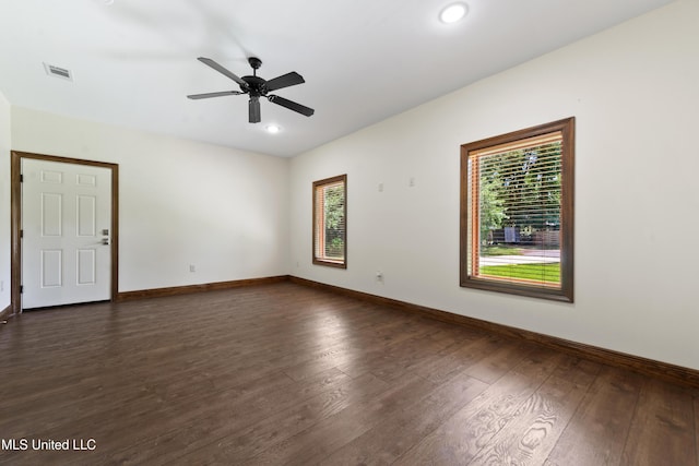 empty room featuring dark wood-style floors, baseboards, a ceiling fan, and recessed lighting