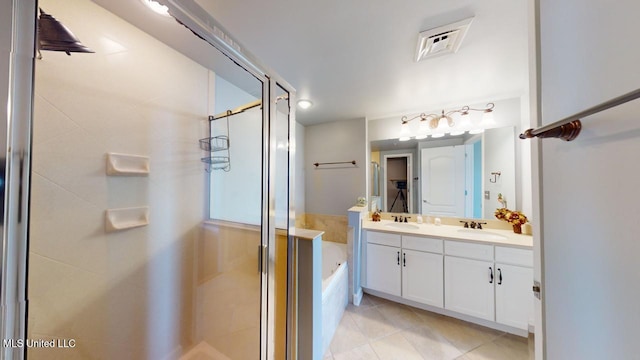 bathroom featuring tile patterned floors, vanity, and independent shower and bath