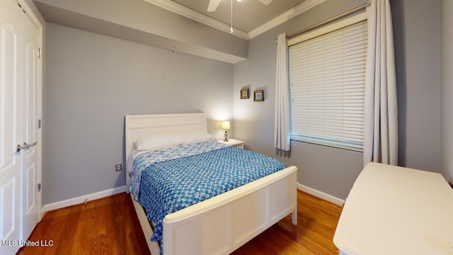 bedroom with hardwood / wood-style floors, ceiling fan, and crown molding