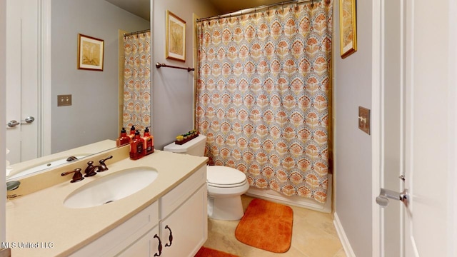 bathroom featuring tile patterned floors, vanity, and toilet