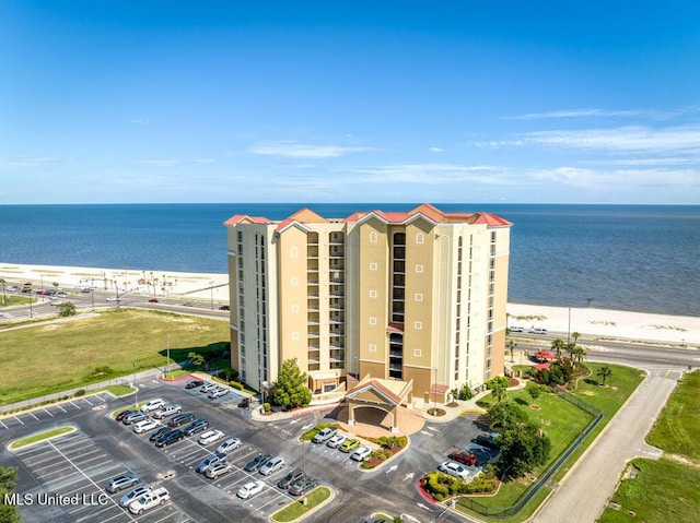 birds eye view of property with a water view and a view of the beach