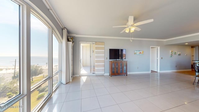 unfurnished living room featuring ceiling fan, a water view, light tile patterned floors, and crown molding