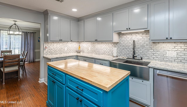 kitchen with blue cabinets, a sink, dark wood-style floors, butcher block counters, and dishwasher