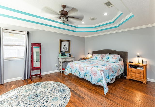 bedroom featuring a raised ceiling, visible vents, and wood-type flooring