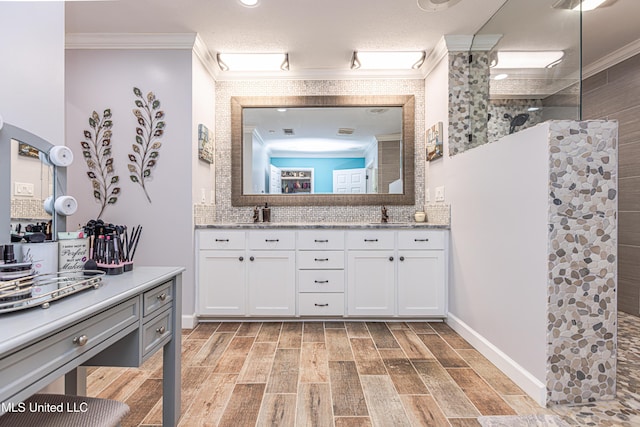 bathroom with a walk in shower, double vanity, ornamental molding, decorative backsplash, and wood finished floors