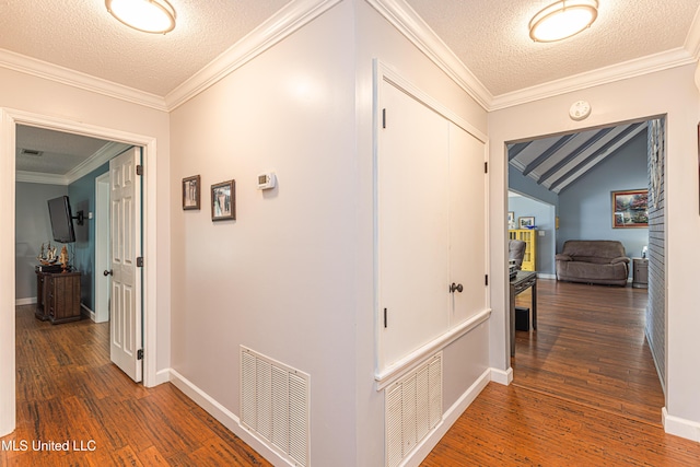 hall featuring visible vents, crown molding, and wood finished floors