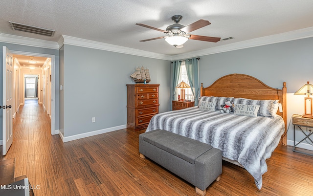 bedroom featuring attic access, wood finished floors, visible vents, and a textured ceiling