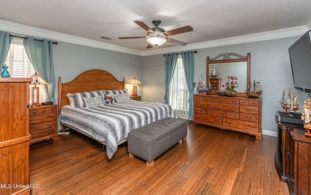 bedroom featuring crown molding, wood finished floors, and a textured ceiling