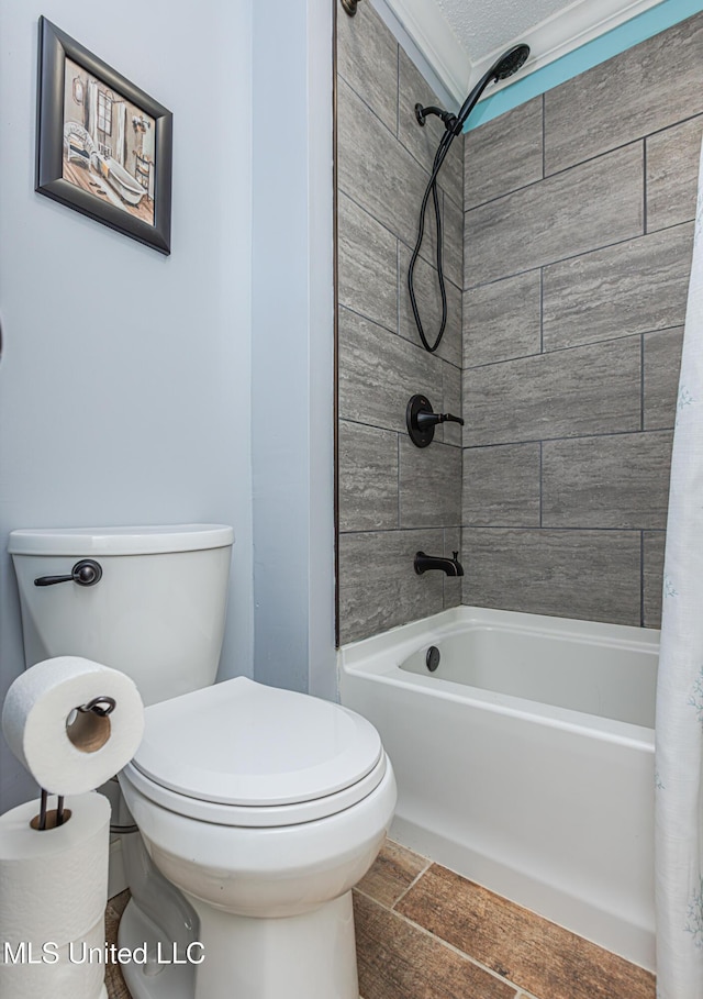 bathroom featuring shower / bath combination with curtain and toilet