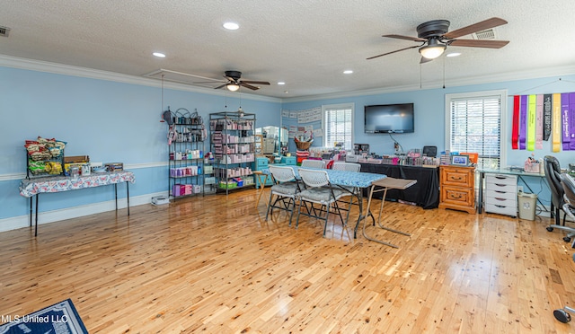 home office featuring attic access, ornamental molding, a ceiling fan, and hardwood / wood-style flooring