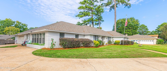 single story home featuring brick siding, concrete driveway, a garage, and a front yard