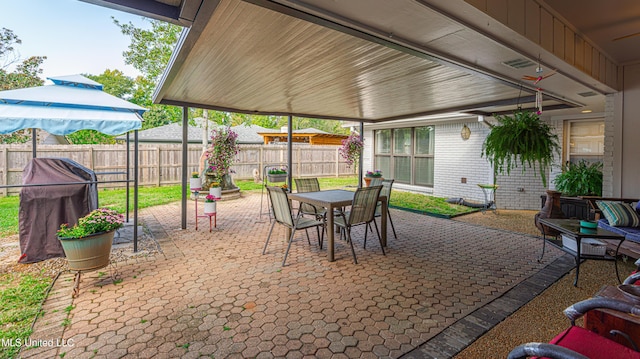 view of patio featuring outdoor dining area and fence