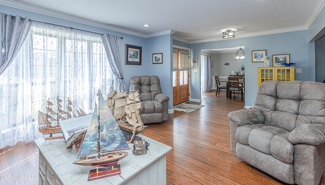 living area featuring a textured ceiling, crown molding, and wood finished floors