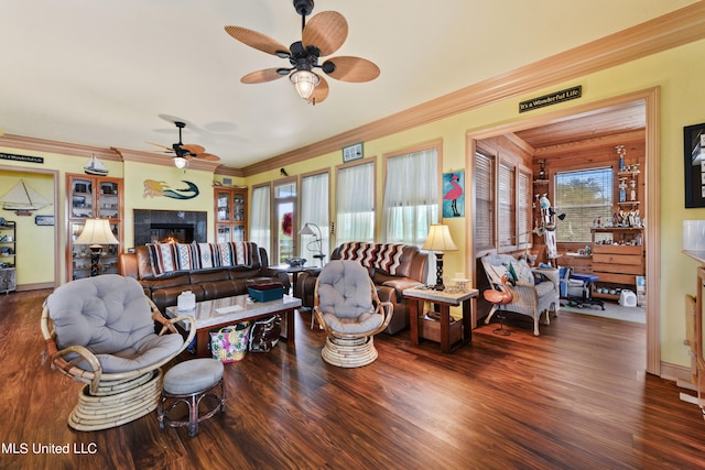 living room with crown molding, dark hardwood / wood-style floors, and ceiling fan