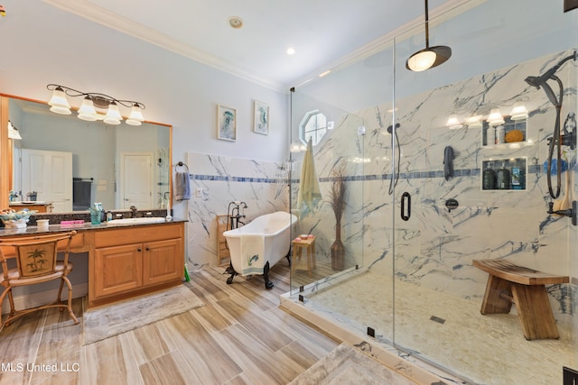 bathroom featuring plus walk in shower, hardwood / wood-style floors, tile walls, vanity, and crown molding