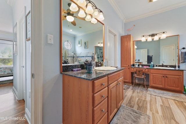 bathroom with vanity, crown molding, and wood-type flooring