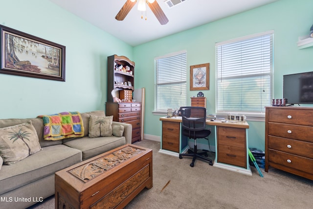 office area featuring light carpet and ceiling fan