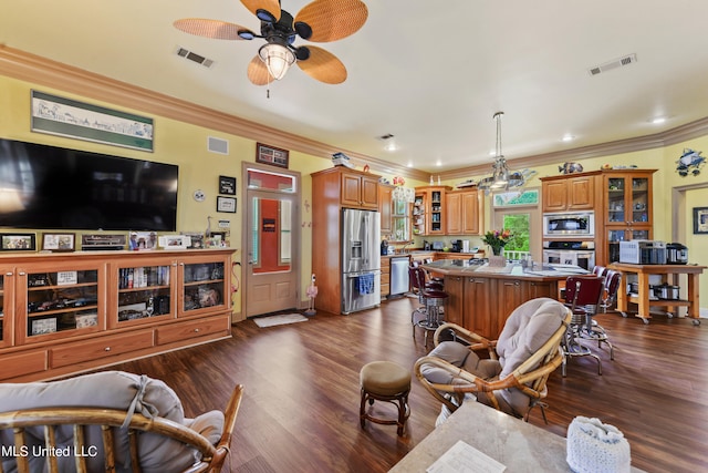 living room featuring ornamental molding, dark hardwood / wood-style floors, and ceiling fan