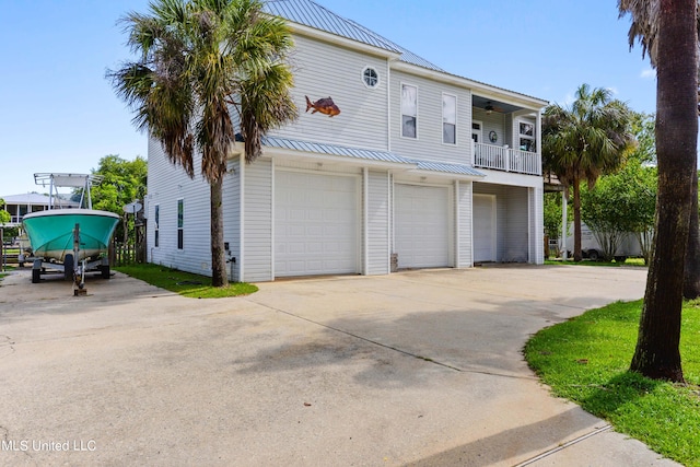 view of front of property with a balcony and a garage