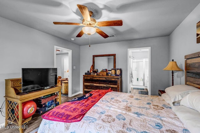 bedroom with connected bathroom, wood finished floors, visible vents, baseboards, and a ceiling fan