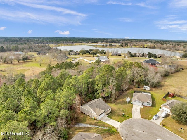 aerial view with a forest view and a water view