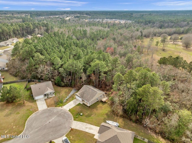 birds eye view of property with a view of trees