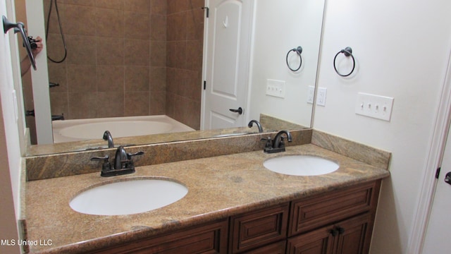 full bathroom with washtub / shower combination, a sink, and double vanity