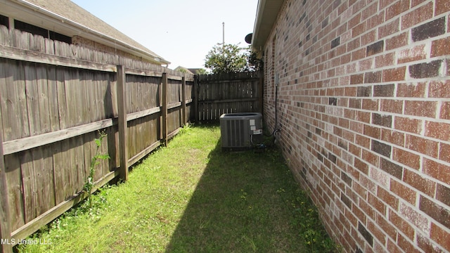 view of yard featuring a fenced backyard and central air condition unit