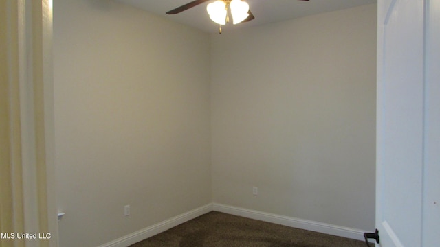 empty room with baseboards, dark carpet, and ceiling fan