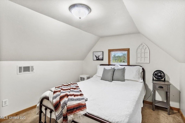 carpeted bedroom with lofted ceiling