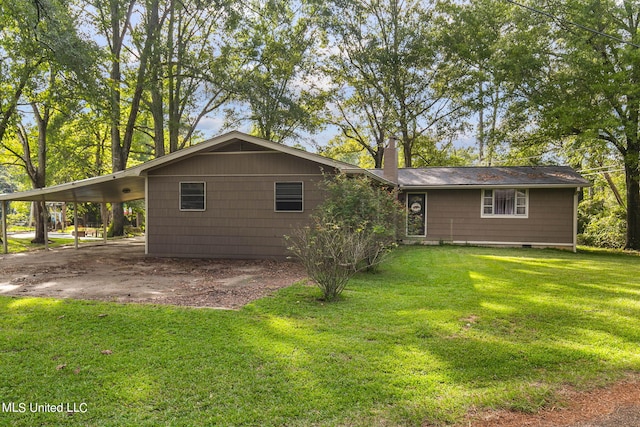 rear view of house with a yard and a carport