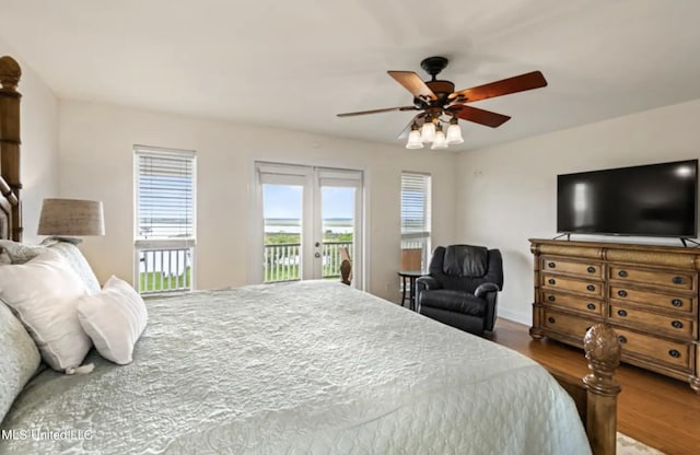 bedroom featuring french doors, access to exterior, wood-type flooring, and ceiling fan