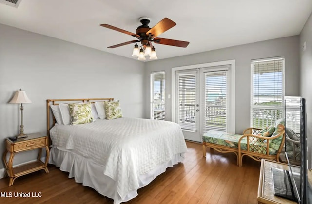 bedroom with french doors, dark hardwood / wood-style floors, access to exterior, and ceiling fan