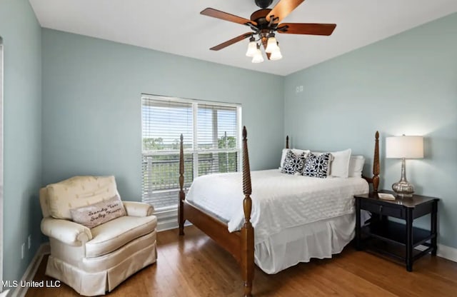 bedroom with ceiling fan and wood-type flooring