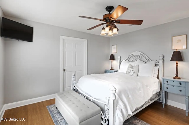 bedroom with ceiling fan and dark hardwood / wood-style flooring