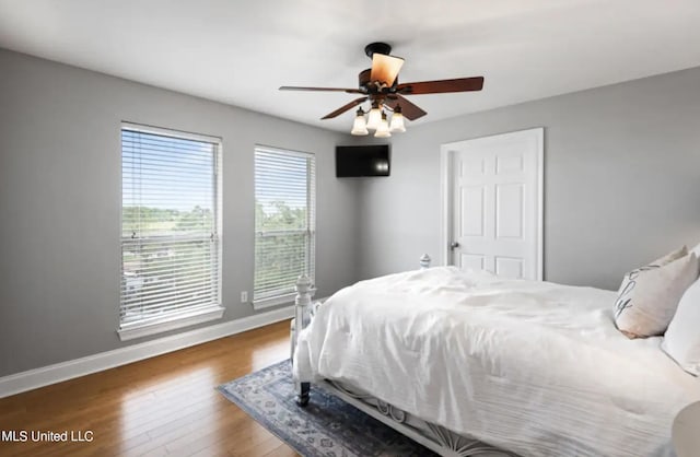 bedroom featuring ceiling fan and dark hardwood / wood-style flooring