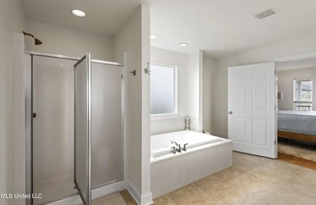 bathroom featuring separate shower and tub