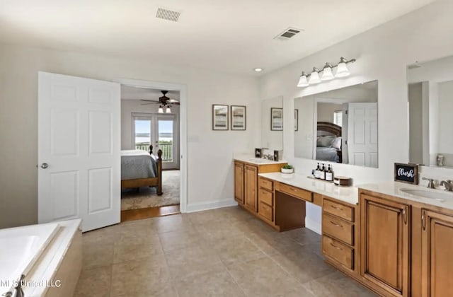 bathroom with vanity, ceiling fan, tiled bath, and tile patterned flooring