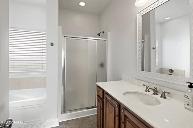 bathroom featuring vanity, separate shower and tub, and tile patterned flooring