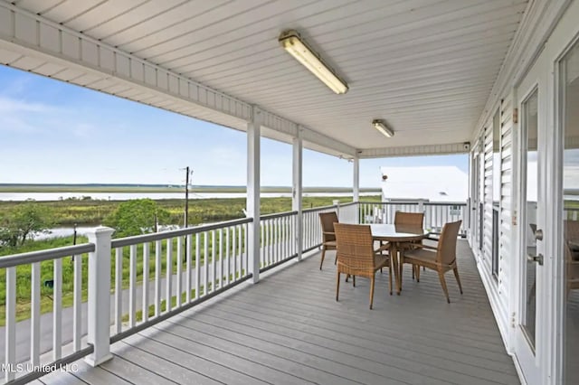 wooden terrace featuring a water view