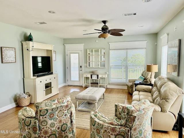 living room with ceiling fan and light wood-type flooring