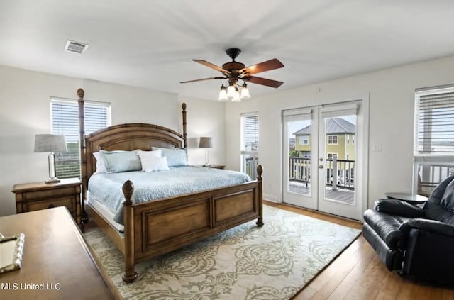 bedroom with french doors, light hardwood / wood-style floors, access to outside, and ceiling fan