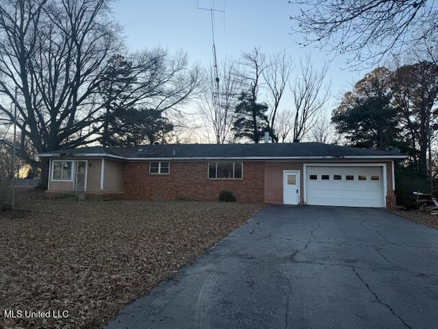 single story home with a garage