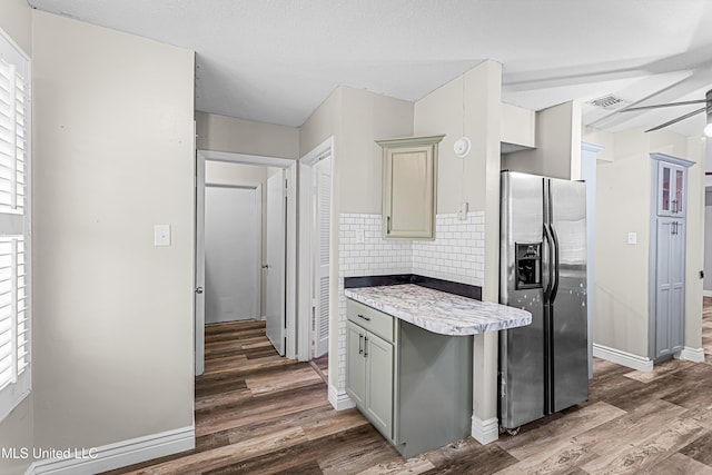 kitchen with visible vents, stainless steel fridge with ice dispenser, tasteful backsplash, and wood finished floors