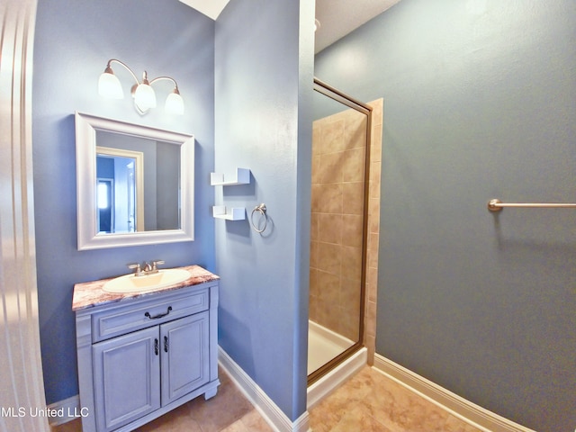 64 Oak Alley Ln, Long Beach, MS 39560 - bathroom featuring a tile shower, vanity, and baseboards