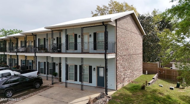 64 Oak Alley Ln, Long Beach, MS 39560 - exterior space with fence, a balcony, and brick siding