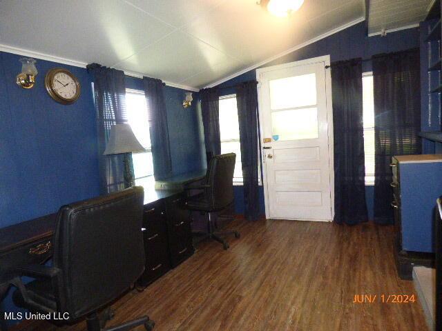 home office with lofted ceiling, ornamental molding, and dark hardwood / wood-style floors