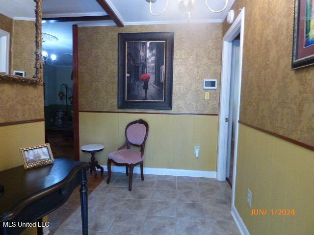 interior space featuring a chandelier and ornamental molding