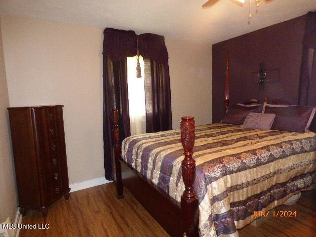 bedroom with hardwood / wood-style flooring and ceiling fan